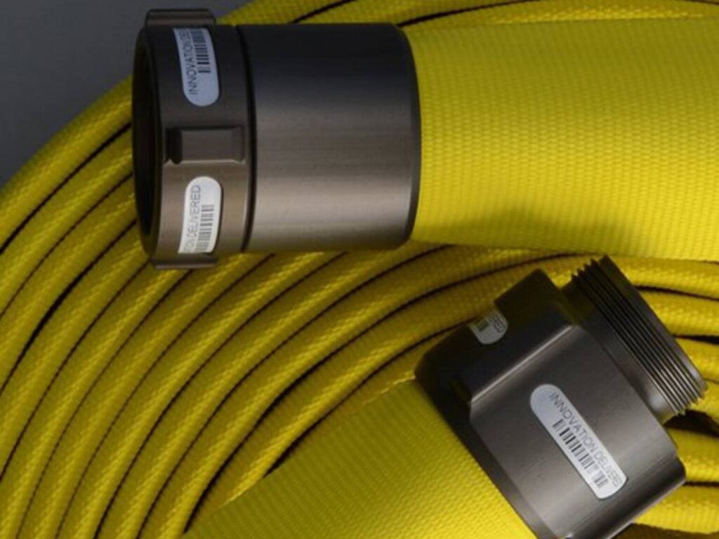 Mercedes Fire Hose coiled with two metallic connectors labeled with barcodes.