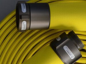 Mercedes Fire Hose coiled with two metallic connectors labeled with barcodes.