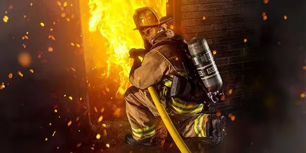 Firefighter using Self Contained Breathing Apparatus after SCBA testing is complete and wearing turnout gear.